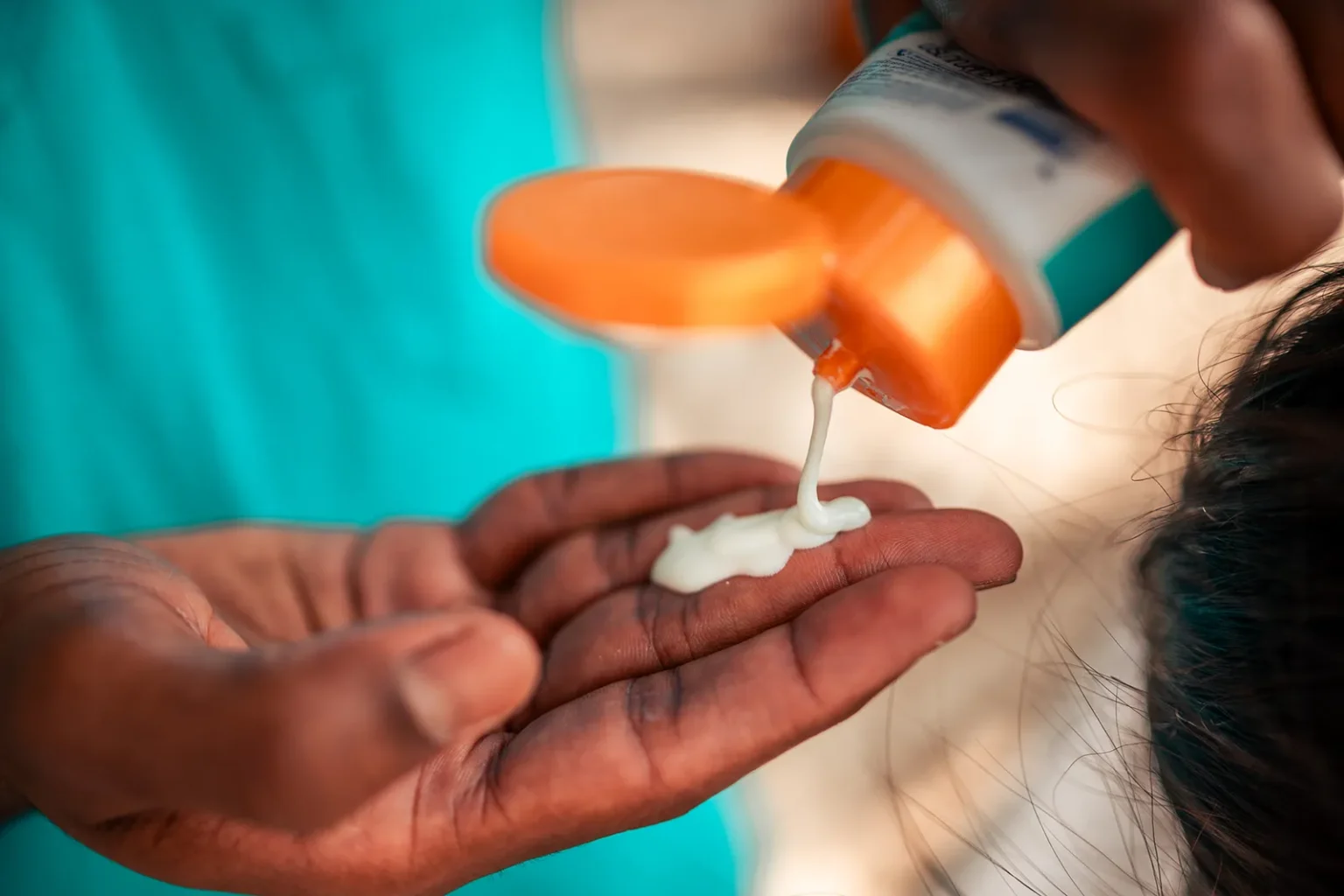 Pouring sunscreen on the hand to protect against UV light